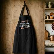 Fakanál Survivor apron displayed in a rustic Hungarian kitchen