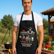 Fit male cook wearing Magyar Apparel Gulyas apron outdoors
