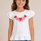 Girl modeling the white Hungarian Matyó ruffle top with red floral embroidery